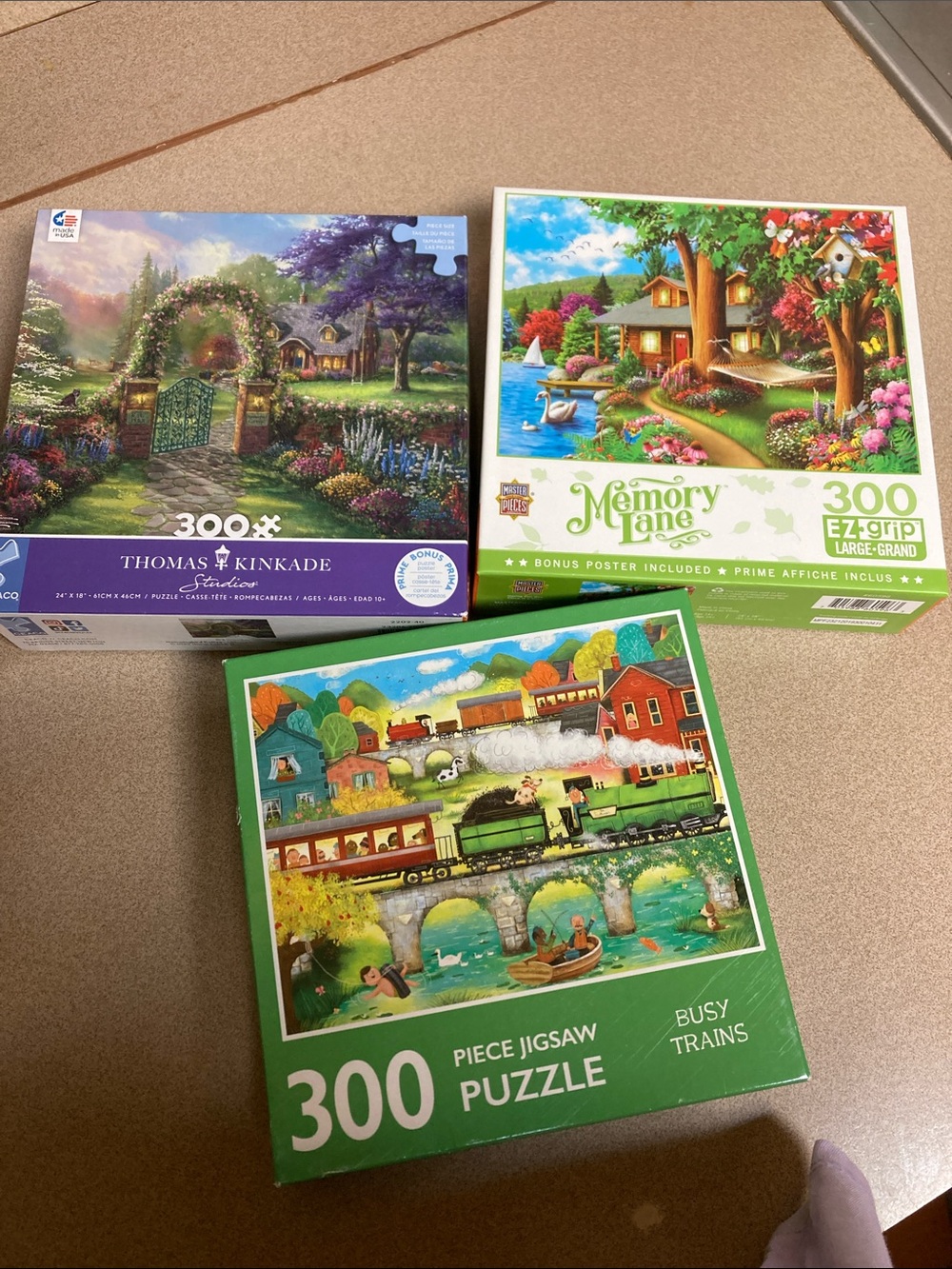 Set of 3-300 piece puzzles featuring Thomas kinkade